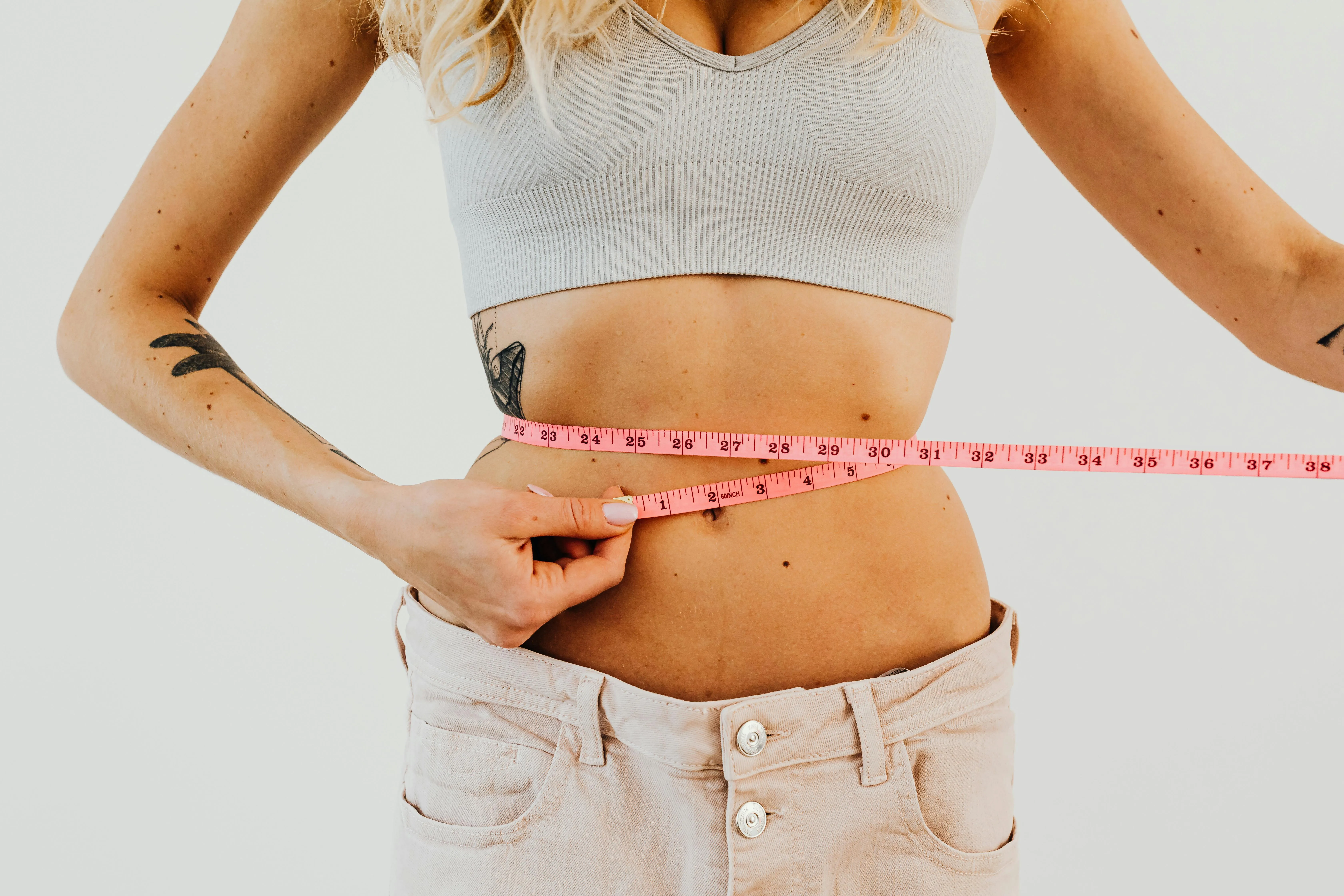 Femme mesurant son tour de taille - suivi de la perte de poids